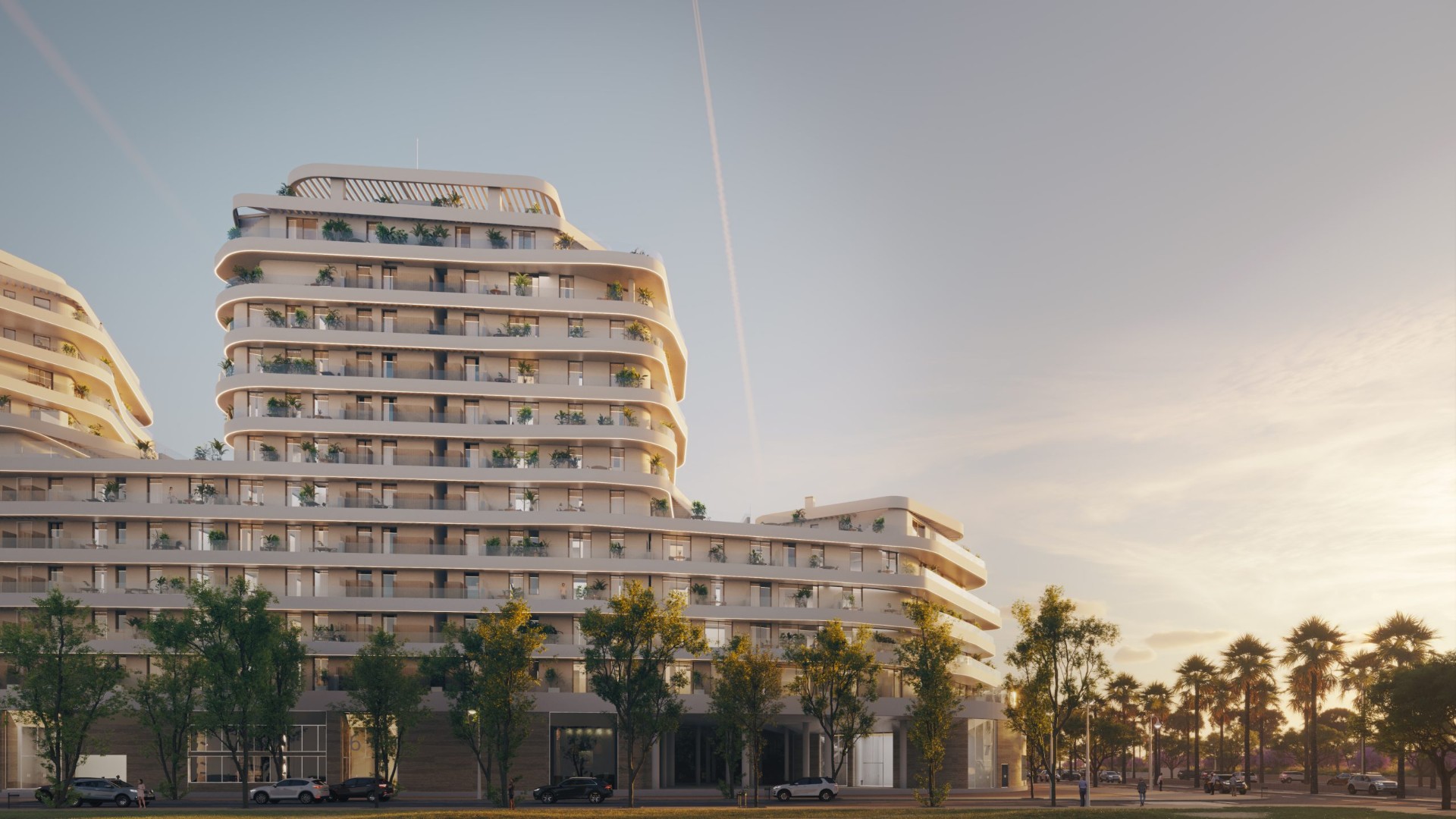 Moderní luxusní rezidenční budova Termica Beach s vlnitými balkony při západu slunce v Málaze